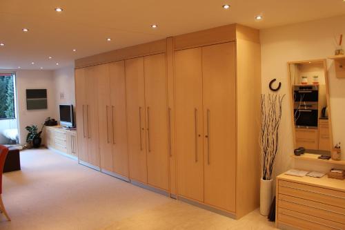 a large room with wooden cabinets in a kitchen at Laax Rancho Residence in Laax