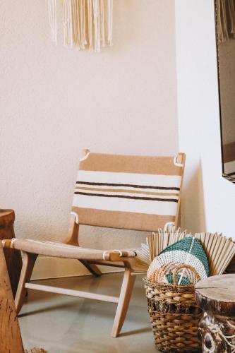 a wooden chair in a room with a basket at Notarius Hotel Bodrum in Bodrum City