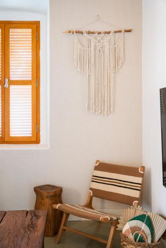 a living room with a chair and a window at Notarius Hotel Bodrum in Bodrum City