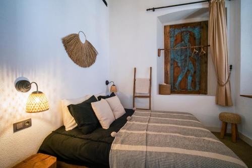 a bedroom with a bed and a painting on the wall at Notarius Hotel Bodrum in Bodrum City
