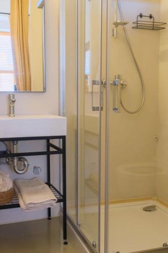 a bathroom with a shower and a sink at Notarius Hotel Bodrum in Bodrum City
