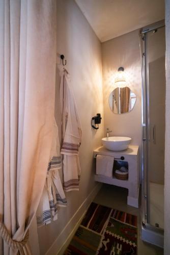 a bathroom with a sink and a shower at Notarius Hotel Bodrum in Bodrum City