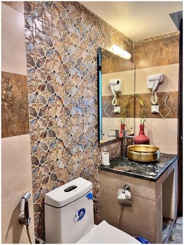 a bathroom with a toilet and a sink and a mirror at Satkar Boutique Home in Kathmandu
