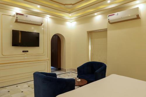 a meeting room with a tv and a table and chairs at HOTEL CITY PALACE in Bikaner