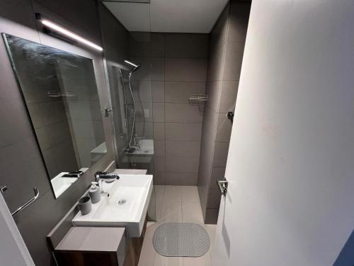 a bathroom with a sink and a mirror at Vacation Like Royalty Every Time in Sharjah