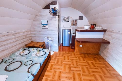 a small room with a bed and a sink at MegaBuena Beach Resort in Mansalay