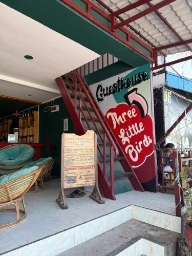 a restaurant with a sign in front of a building at Three Little Birds Bar & Guesthouse in Koh Rong