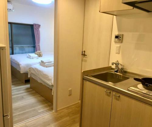 Postel nebo postele na pokoji v ubytování KOSUMOSU Ikebukuro Shinjuku Private House