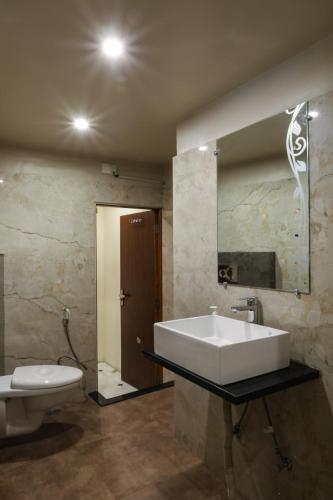 a bathroom with a sink and a toilet at HOTEL CITY PALACE in Bikaner
