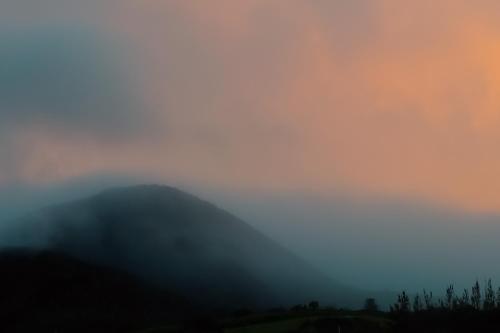 a foggy view of a mountain range with hills at Au Châlet in Le Tampon