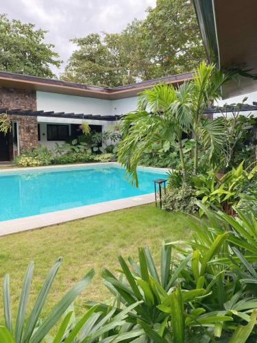 a swimming pool in the yard of a house at Acquatro Suites in San Fernando
