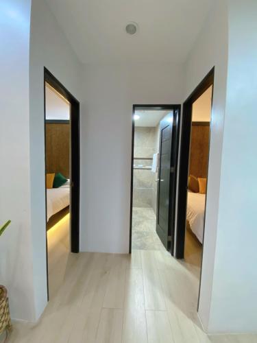 two doors in a room with two beds at Acquatro Suites in San Fernando