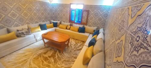a living room with a couch and a table at Résidence chez Said in Sidi Ifni