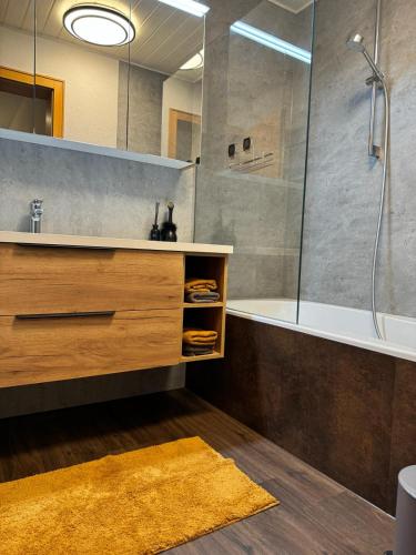 a bathroom with a shower and a sink and a tub at Chalet 1480 in Gaschurn