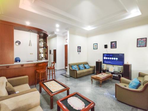 a living room with couches and a flat screen tv at Palma Villa Homestay Klaten in Kuwoso