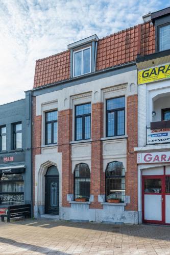 a brick building on a city street at Temse city center in Temse