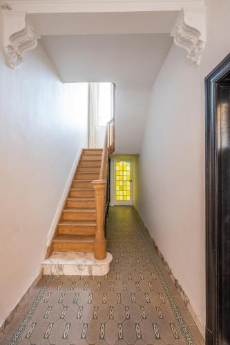 an empty hallway with stairs in a house at Temse city center in Temse