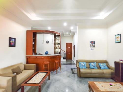 a living room with two couches and a bar at Palma Villa Homestay Klaten in Kuwoso