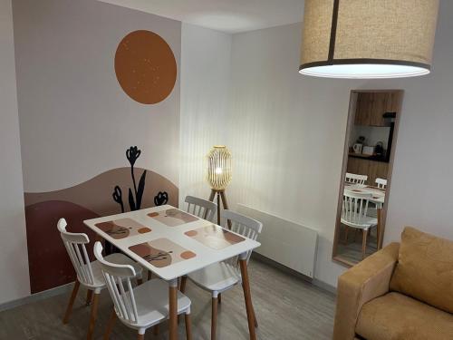 un salon avec une table, des chaises et un canapé dans l'établissement Charmant T2 Via Rhôna - 4 min St Vallier, à Ponsas