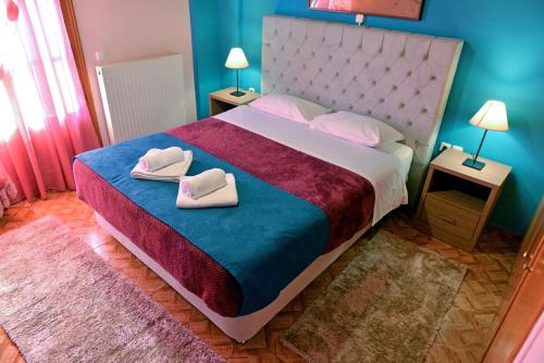 a bedroom with a bed with two towels on it at Patriko in Arachova