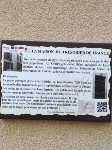 a sign on the wall of a house at Les Remparts in Caudiès-de-Fenouillèdes