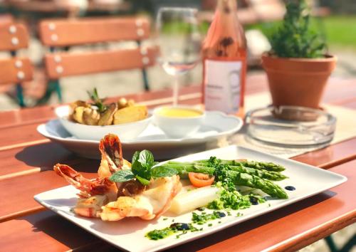 a plate of food with shrimp and vegetables on a table at Gasthof Maria Kirchental in Sankt Martin bei Lofer