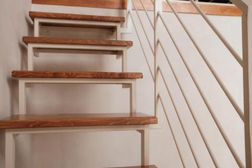 a set of stairs with wooden shelves in a room at Midi Pool Villa & SPA in Veglie