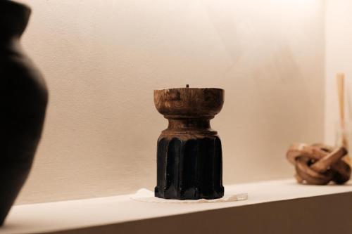 a small black vase sitting on a shelf at Midi Pool Villa & SPA in Veglie