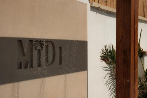 a sign on the side of a building at Midi Pool Villa & SPA in Veglie