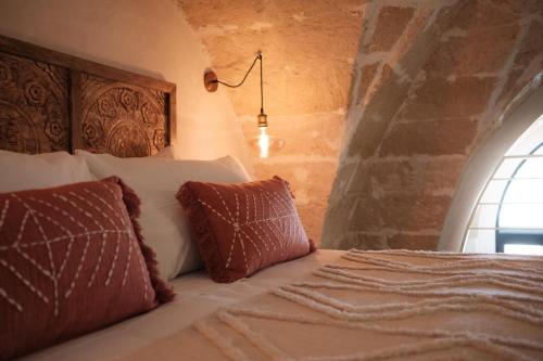 a bedroom with a bed with two pillows at Midi Pool Villa & SPA in Veglie