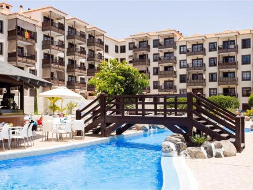 a bridge over a pool in front of a building at Costa del Silencio Balcon del mar Summer Tenerife in Arona