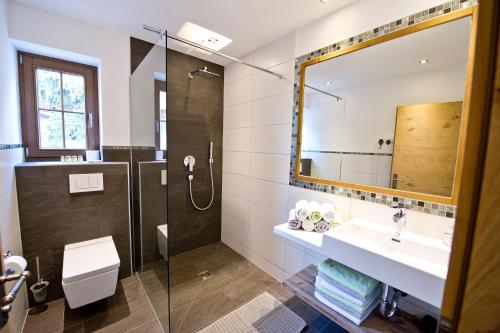 a bathroom with a sink and a shower at Superior Chalet Tiroler Madl in Achenkirch