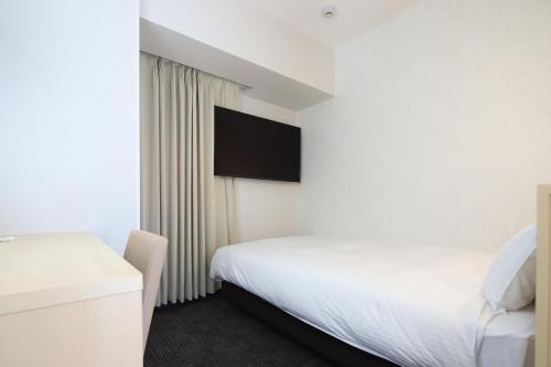 Postel nebo postele na pokoji v ubytování AB Hotel Konan