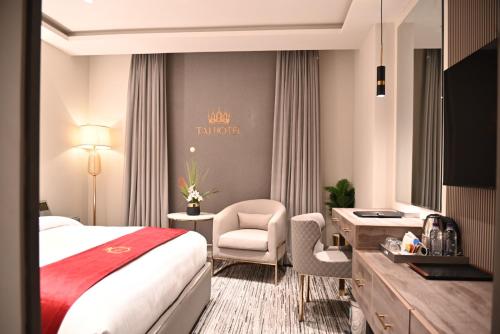 a hotel room with a bed and a desk at TAJ Hotel in Islamabad