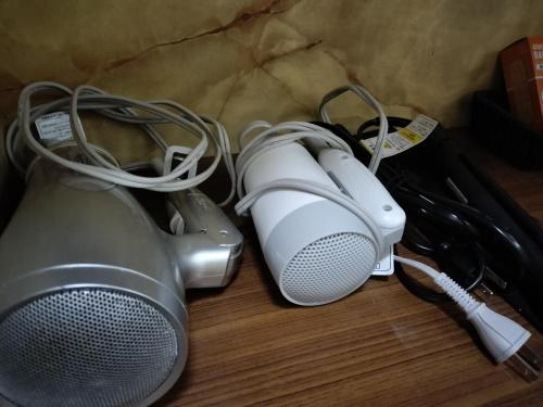 a pair of headphones and speakers sitting on a table at Guesthouse Naruto Ohenro ゲストハウス鳴門 おへんろ in Naruto