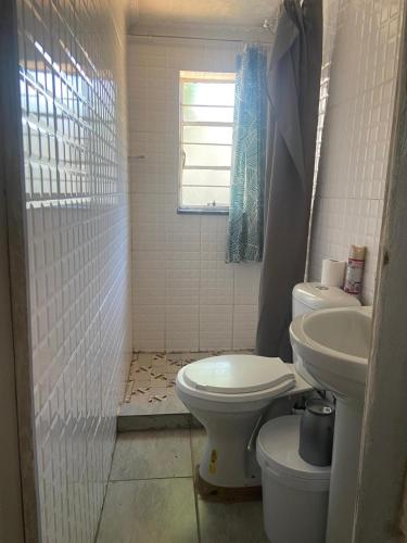 a bathroom with a toilet and a sink at Bennyz Guest House in Pretoria