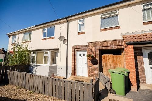 a house with a fence in front of it at Deal House in Stockton-on-Tees