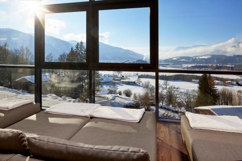 a living room with a view of a snowy mountain at Hotel Panorama Royal in Bad Häring