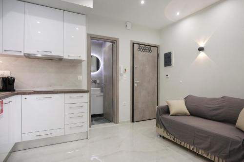 a living room with a couch and a kitchen at #Ioanna apartments RooMore 2 in Thessaloniki