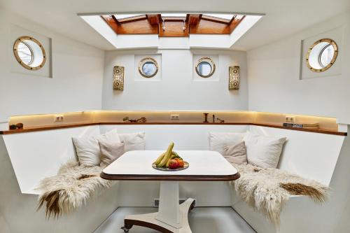 a room with a table and a bowl of fruit at Your Houseboat Amsterdam in Amsterdam