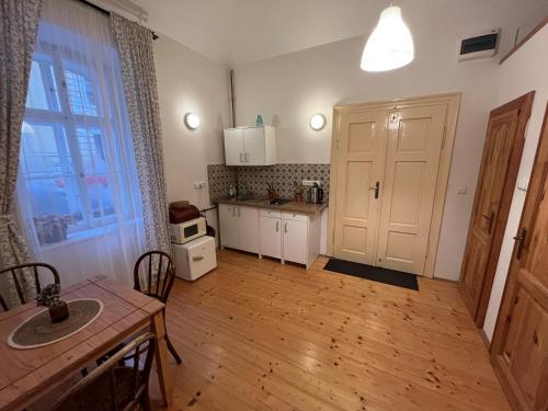a kitchen with a table and a kitchen with a door at Apartment Žižkova 159, Terezín in Terezín