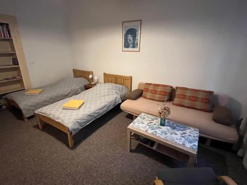 a living room with two beds and a couch at Apartment Žižkova 159, Terezín in Terezín