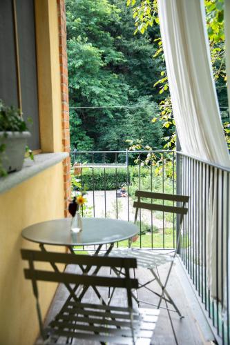 a table and two chairs on a balcony at Agriturismo Biomatto in Arona