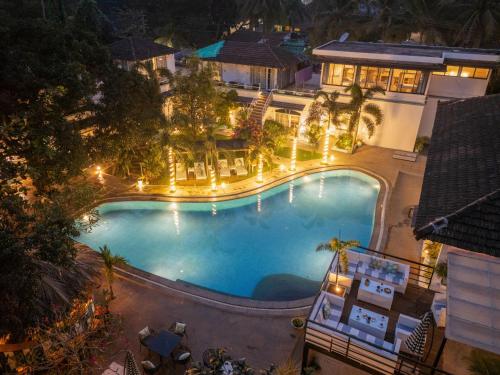 an overhead view of a swimming pool at night at Moustache Goa Luxuria in Vagator