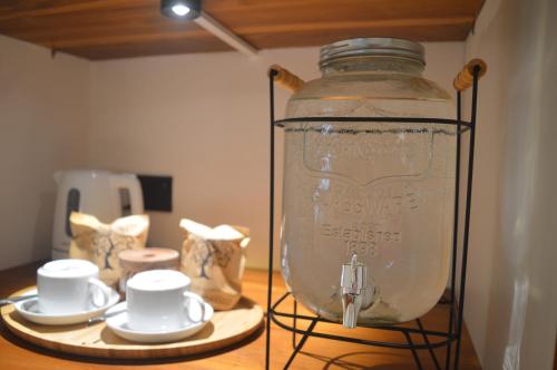 a glass jar with cups and saucers on a table at Madiha Venus in Matara