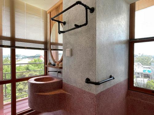 a bathroom with a toilet and a window at The Pink Boutique Hotel in Da Lat