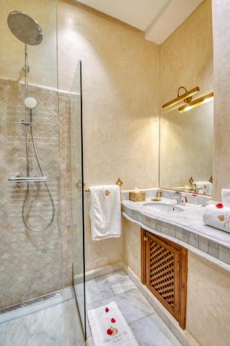 a bathroom with a shower and a sink at Palais Tara & Spa in Marrakech