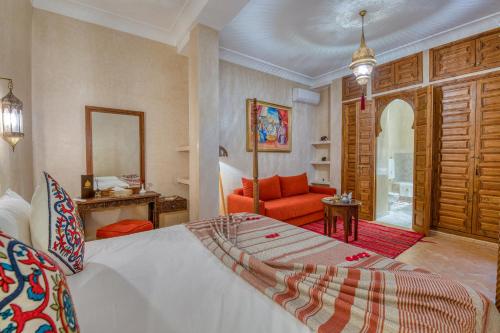 a bedroom with a bed and a living room at Palais Tara & Spa in Marrakech