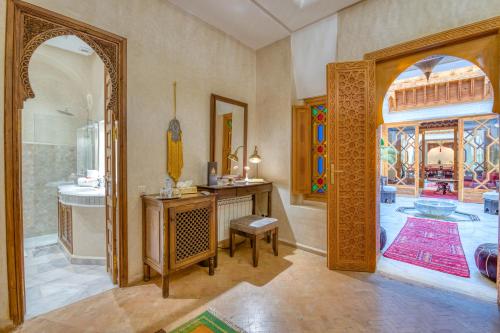 a bathroom with a shower and a sink and a mirror at Palais Tara & Spa in Marrakech
