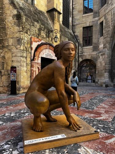 a statue of a woman sitting in front of a building at Village villa, private pool, canal du midi in Argens Minervois